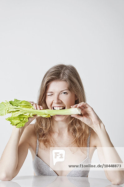 woman biting celery