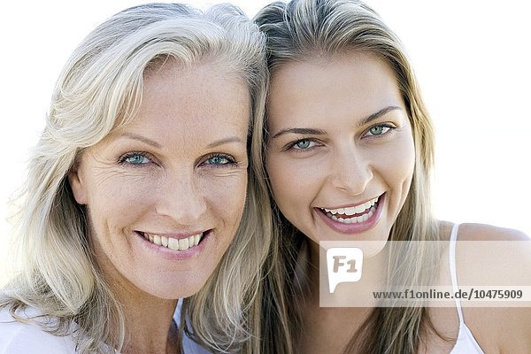 MODEL RELEASED. Mother and adult daughter smiling. Mother and daughter