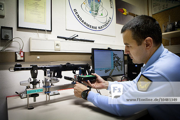 Reportage in the French National Police´s Criminal Research Institute in Rosny-sous-Bois  France. Ballistics Department. Determining the level of resistance in the trigger to ascertain whether the shot was involuntary or not.