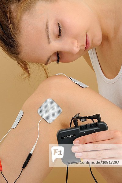 Electrodes in pads attached to a woman  transcutaneous electronic nerve stimulation