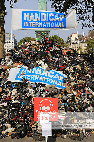 Pyramid of shoes. Demonstration against mines and cluster bombs in Paris. NGO Handicap International.