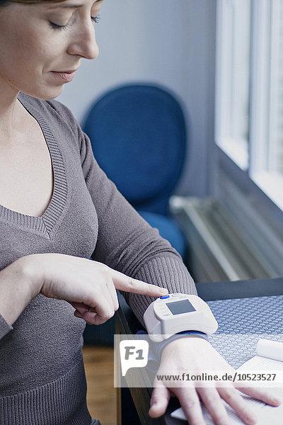 Woman measuring her blood pressure.