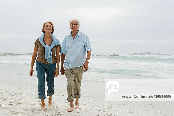 Senior couple walking along a beach