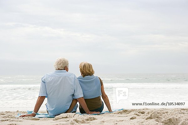 Senior couple sitting on a beach