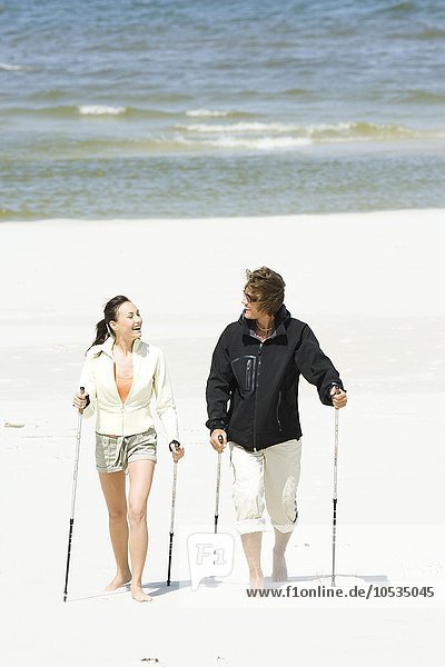 couple hiking on beach