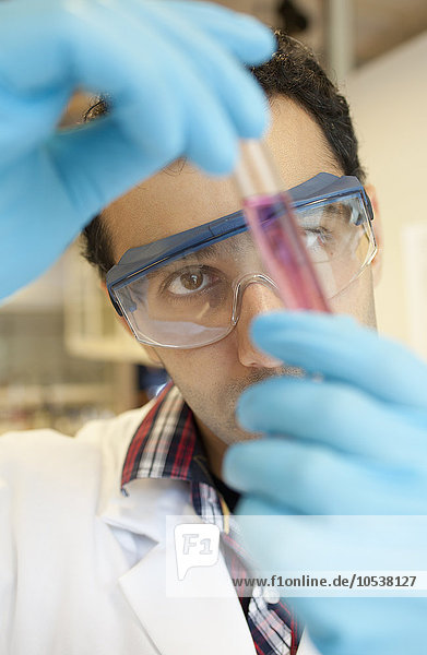 Scientist examining liquid in test tube