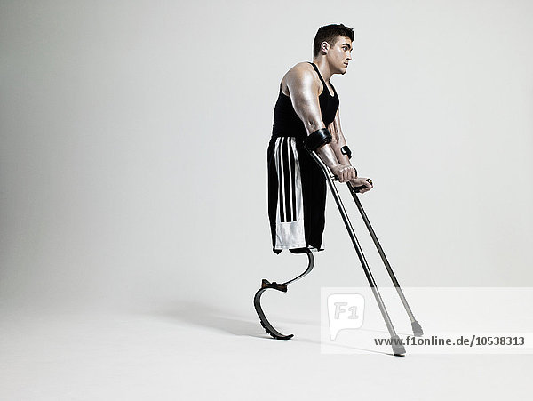 Man with crutches and prosthetic leg