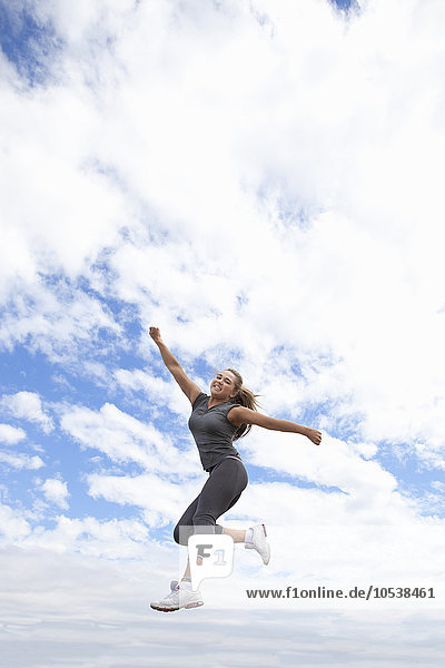 Runner jumping for joy outdoors