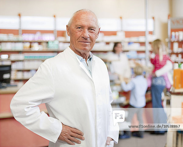 Smiling pharmacist standing in store