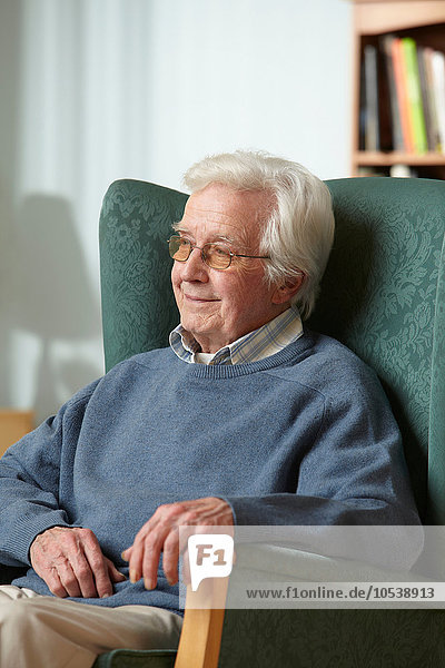 Senior man in armchair  portrait