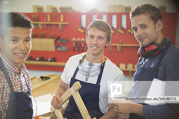 Portrait confident carpenters in workshop