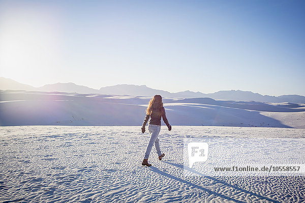 Caucasian woman walking in White Sands National Park  New Mexico  United States