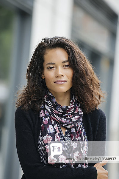 Mixed race woman standing in city