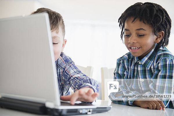 Close up of boys using laptop at desk
