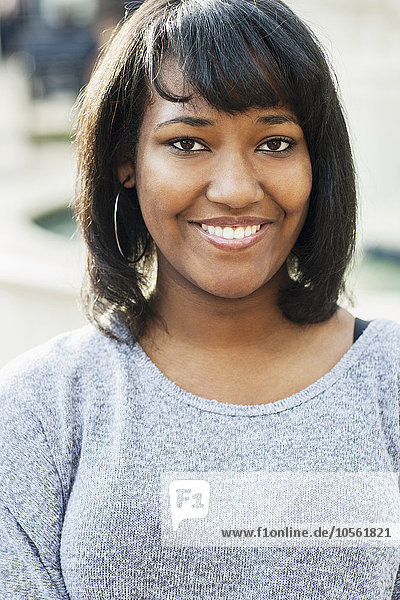 African American teenage girl smiling outdoors