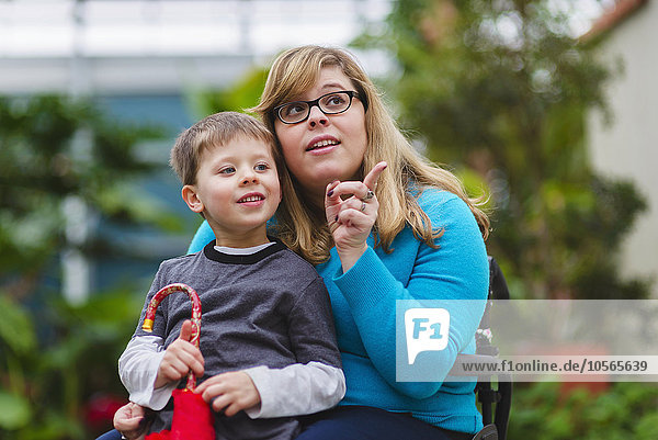 Paraplegic mother and son exploring outdoors