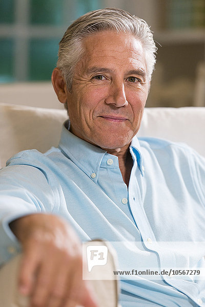 Caucasian businessman smiling on sofa