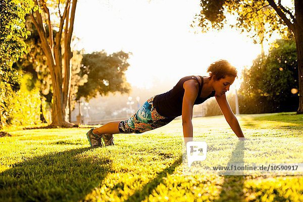 Woman doing push ups in park
