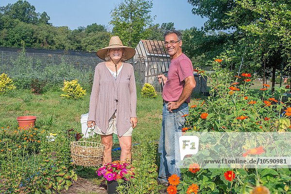Portrait of male and female farmers in garden