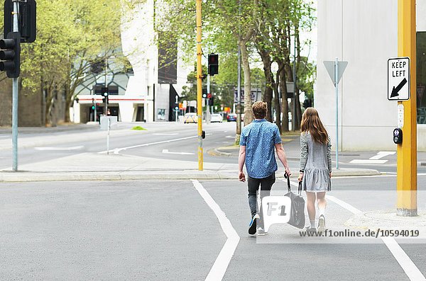 Young couple carrying bag together on street  Melbourne  Victoria  Australia