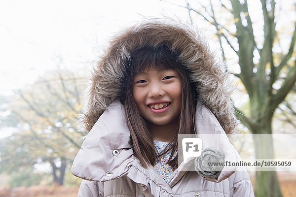 Portrait of young girl wearing winter coat  smiling
