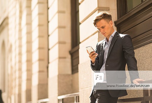 Businessman using phone  London  UK
