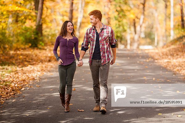 Romantic young couple strolling in autumn forest