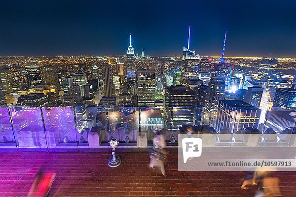 High angle view of midtown Manhattan and tourists at night  New York  USA