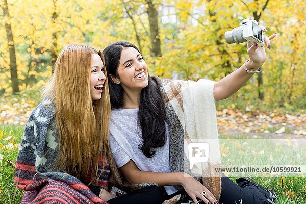 Young women taking selfie in forest  Hampstead Heath  London