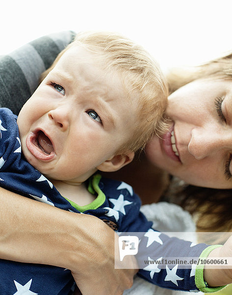 Mother holding crying boy