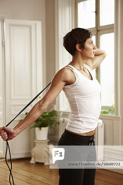 Woman stretching with skipping rope