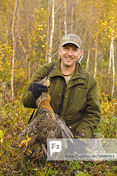 Man with dead Common Pheasant