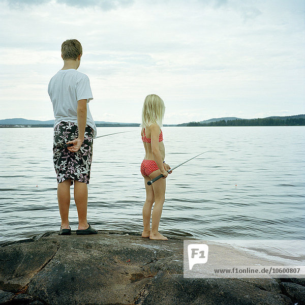 Children fishing in lake