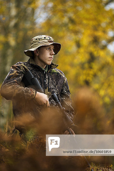 Teenage boy with rifle at hunting