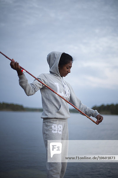 Young woman fishing at evening