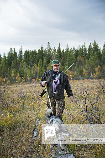 Senior man hunting with dog