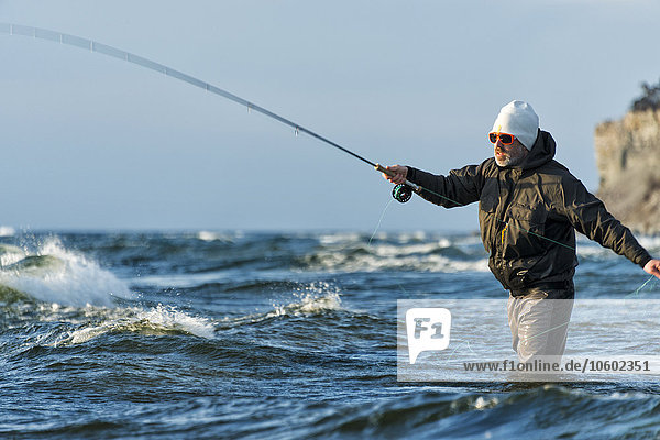 Man fishing in Baltic Sea  Gotland  Sweden