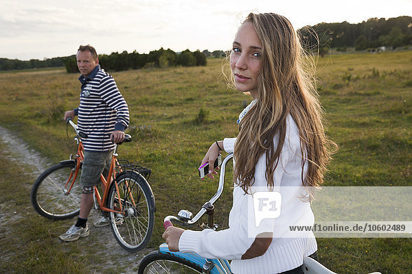 Father with teenage daughter cycling  Oland  Sweden