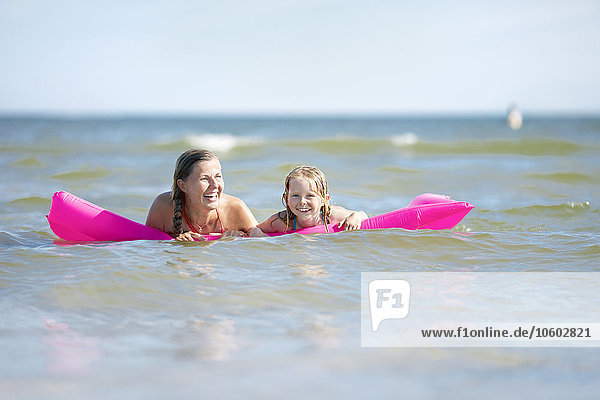Mother with daughter on inflatable raft