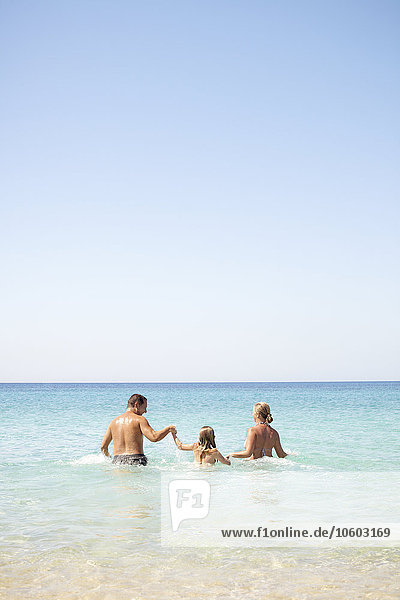 Parents with daughter in sea