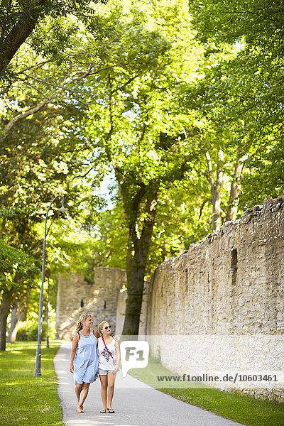Mutter und Tochter gehen entlang der Festungsmauer