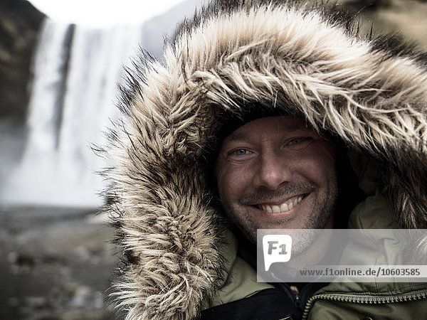 Smiling man wearing hood