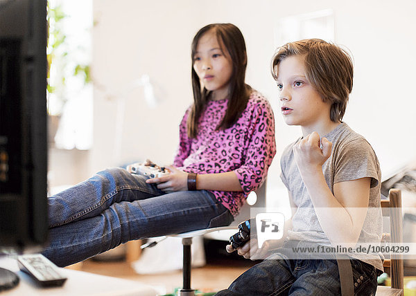 Boy and girl playing video game