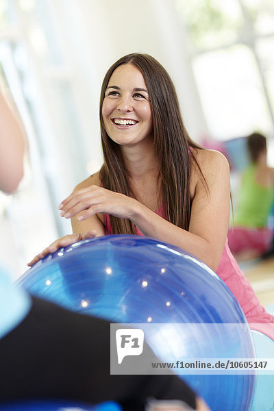 Smiling woman with fitness ball