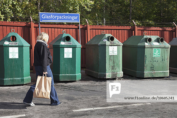 Frau in der Nähe der Recycling-Tonne