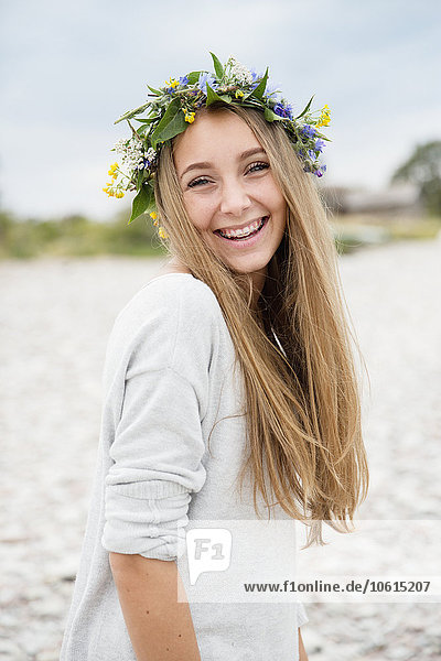 Smiling teenage girl wearing flower wreath