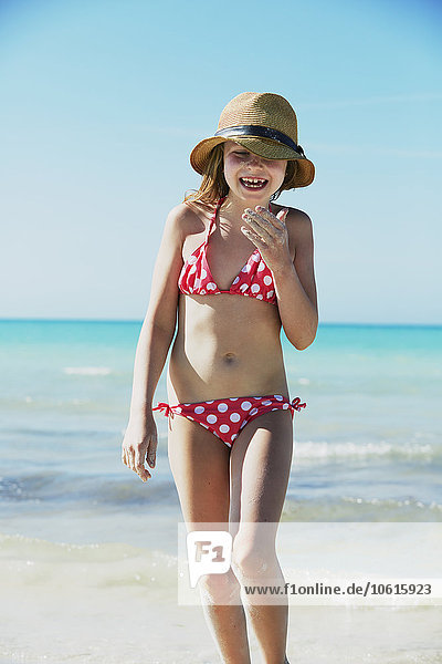 Girl wearing bikini walking on beach