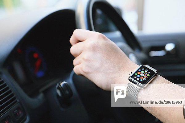 Japanese man in the car with wearable smart watch