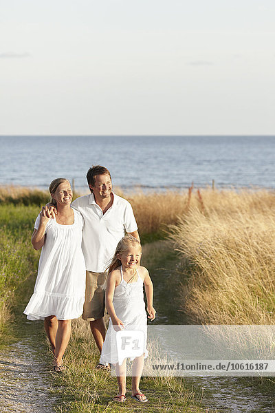 Family walking at sea