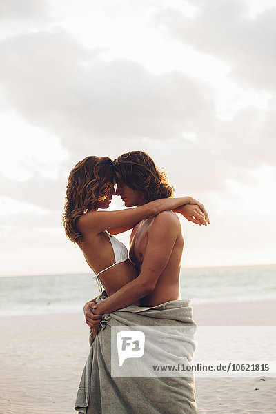 Romantic young couple embracing each other on the beach